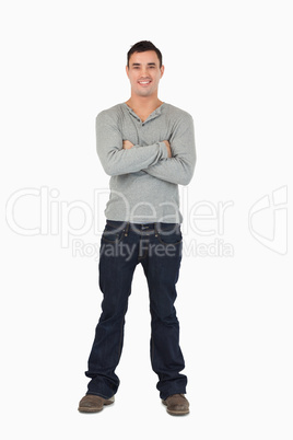 Young male standing with arms folded