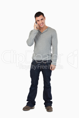 Young male standing while on the phone