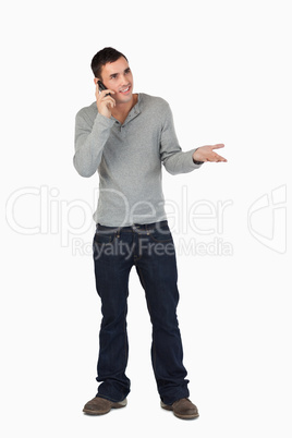 Young male gesturing while on the phone