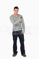 Young male writing text message while standing