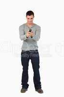 Young male reading text message
