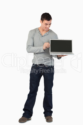 Young male showing his laptop