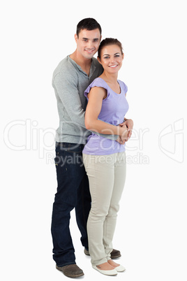 Side view of young male holding his girlfriend