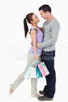 Young couple hugging during shopping tour
