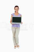 Smiling young female presenting her laptop screen