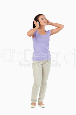 Young female enjoying music with headphones on