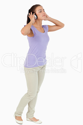 Young female listening to music with headphones on