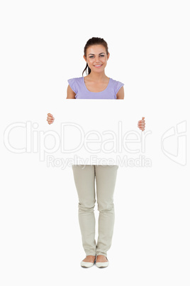 Young female holding sign