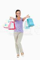 Happy young female presenting her shopping bags