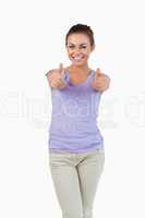 Smiling young female giving thumbs up