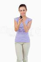 Young female typing text message