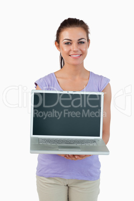 Smiling young female showing her laptop