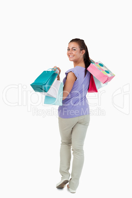 Rear view of young female with her shopping bags