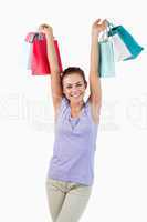 Young female raising her shopping bags