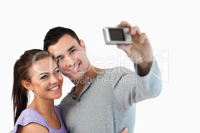 Young couple taking a picture of themselves