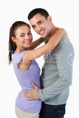 Smiling young couple embracing