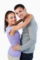Smiling young couple embracing