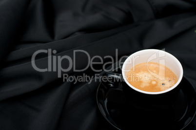 Cup of Coffee on Black Drapery