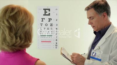 optometrist having his paitent read eye chart
