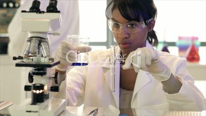 Lab Tech Pouring Liquid in Test Tube