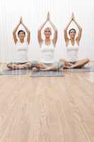 Interracial Group of Three Beautiful Women In Yoga Position