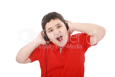 Portrait of a sweet young boy listening to music on headphones a