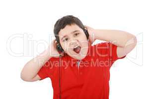 Portrait of a sweet young boy listening to music on headphones a