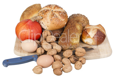 gem, nuts, eggs and a pumpkin on a wooden board