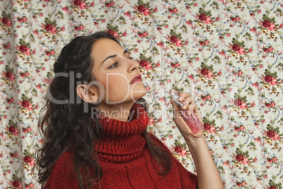 Woman with parfume with colorful floral background