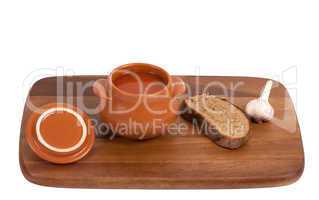 Borsch with bread and garlic on wooden kitchen board