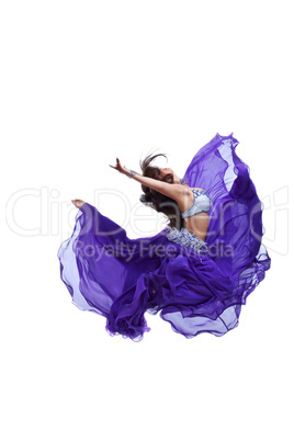 Young girl jump in purple oriental eastern veil