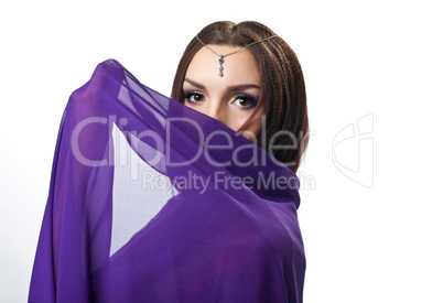 Beauty woman close face by purple cloth