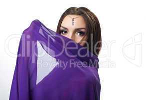 Beauty woman close face by purple cloth