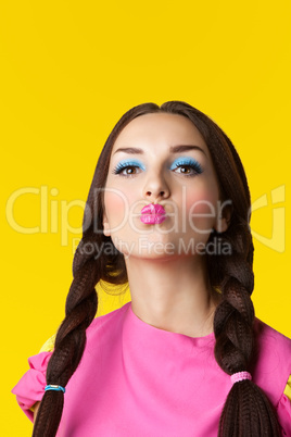 Beauty girl with funny make-up in doll costume