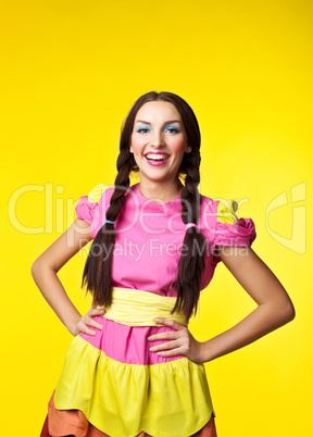 Young girl in doll costume smile on yellow