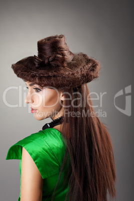 Woman portrait in hair style like hat on grey