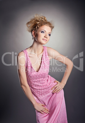 Young beauty woman posing in rose frock