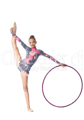 Young gymnast stand on split with hoop