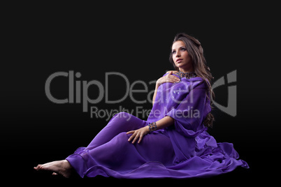 Young girl lay in purple traditional costume