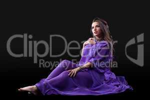 Young girl lay in purple traditional costume