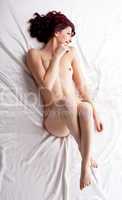 red naked girl lay on white silk bed