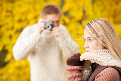 Autumn man make photo of young woman