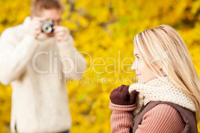 Autumn man make photo of young woman