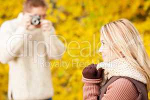 Autumn man make photo of young woman