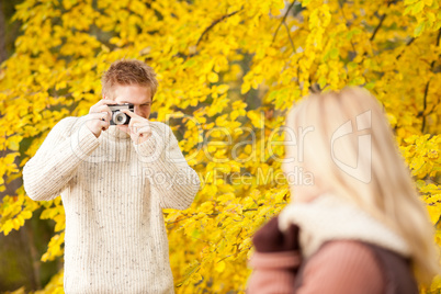 Autumn man make photo of young woman