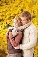Autumn romantic couple happy hugging in park
