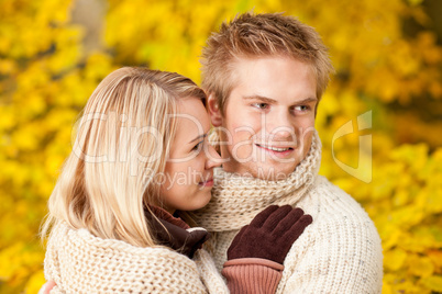 Autumn happy couple hugging together park scenery