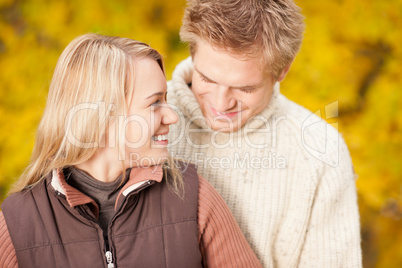 Autumn happy couple hugging together in park