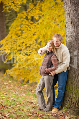 Autumn romantic couple smiling together in park