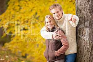Autumn romantic couple smiling together in park
